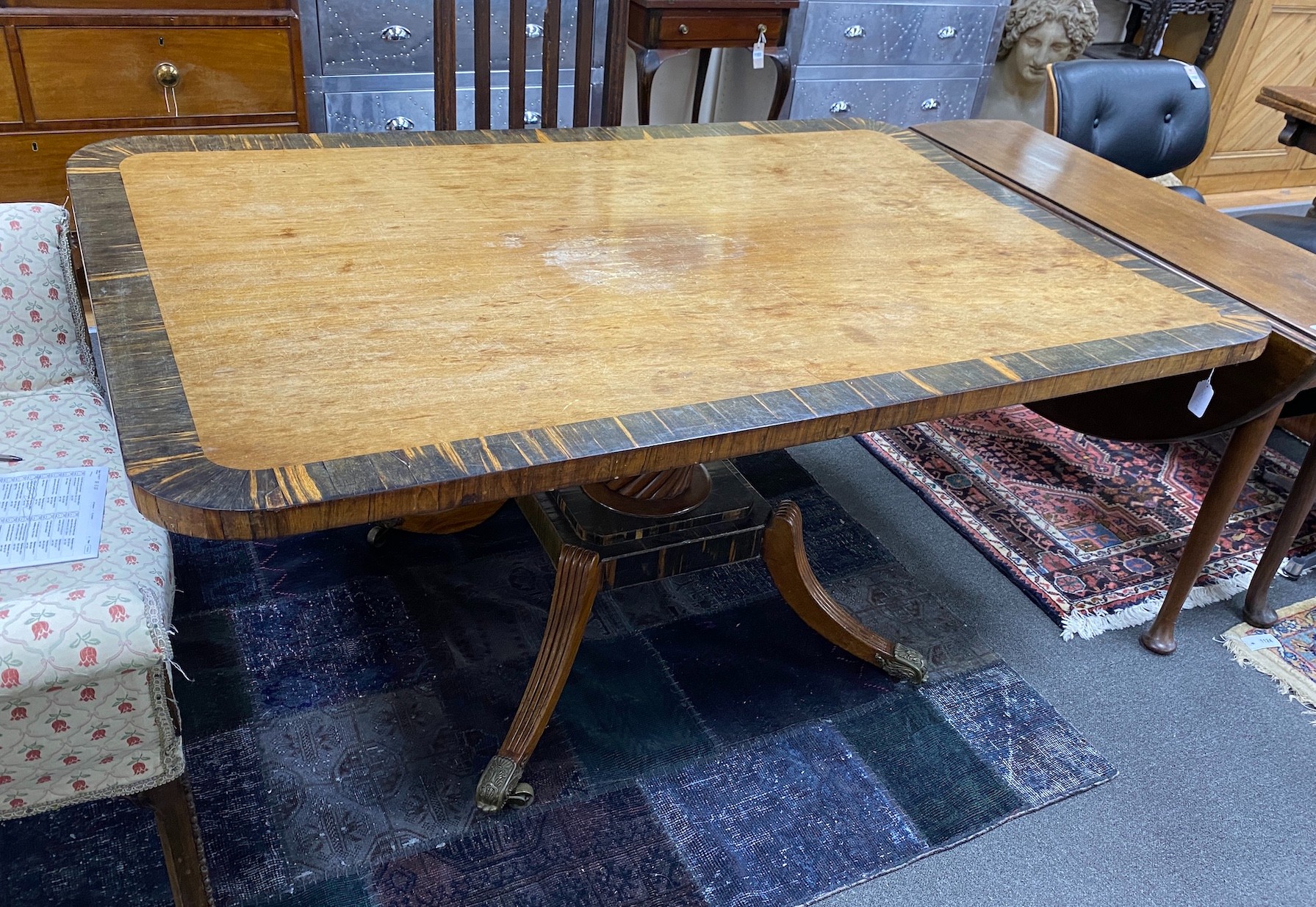 A Regency coromandel banded rectangular mahogany tilt top dining table, length 160cm, width 106cm, height 74cm